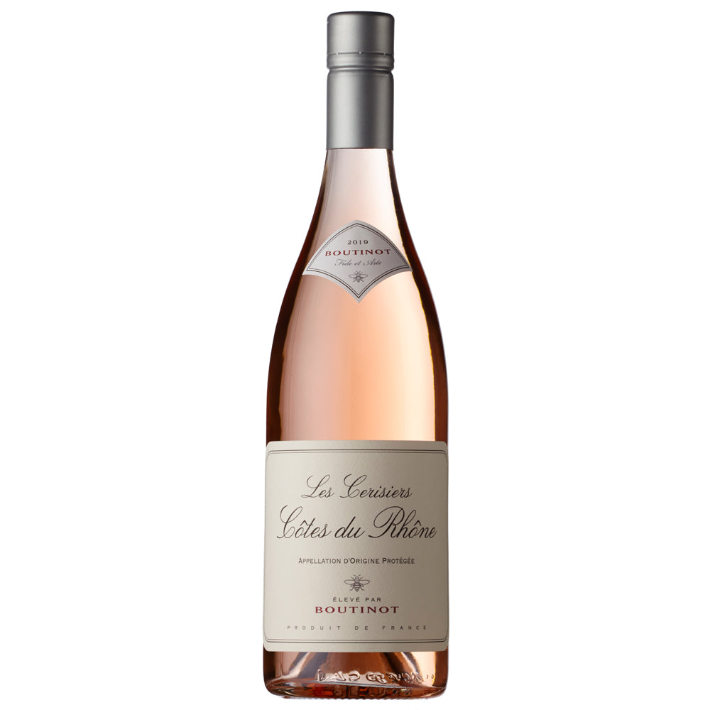 A bottle of Boutinot Les Cerisiers Cotes du Rhone rose wine. It has a white label with blavk and red writing. I has a silver screw cap.