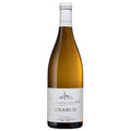 A bottle of De la Motte Chablis white wine. It has a white label and a white foil capsule.