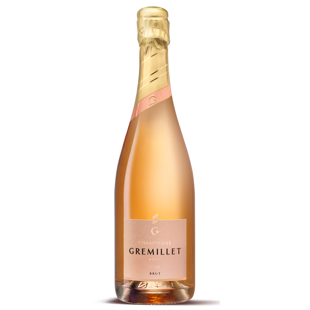 A bottle of Gremillet rose Champagne. It has a pink label with black and gold writing. There is a gold and pink foil capsule. The picture is set on a white background.