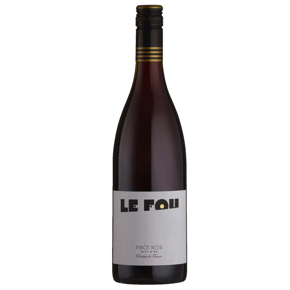 A bottle of Le Fou Pinot Noir. It has a white label with black writing and a black and gold screw cap.