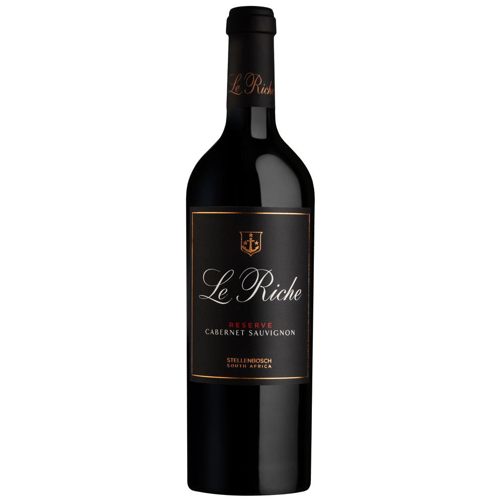 A bottle of Le Riche Reserve Cabernet Sauvignon red wine, featuring a black glass bottle with a black label and gold accents, set against a plain white background.