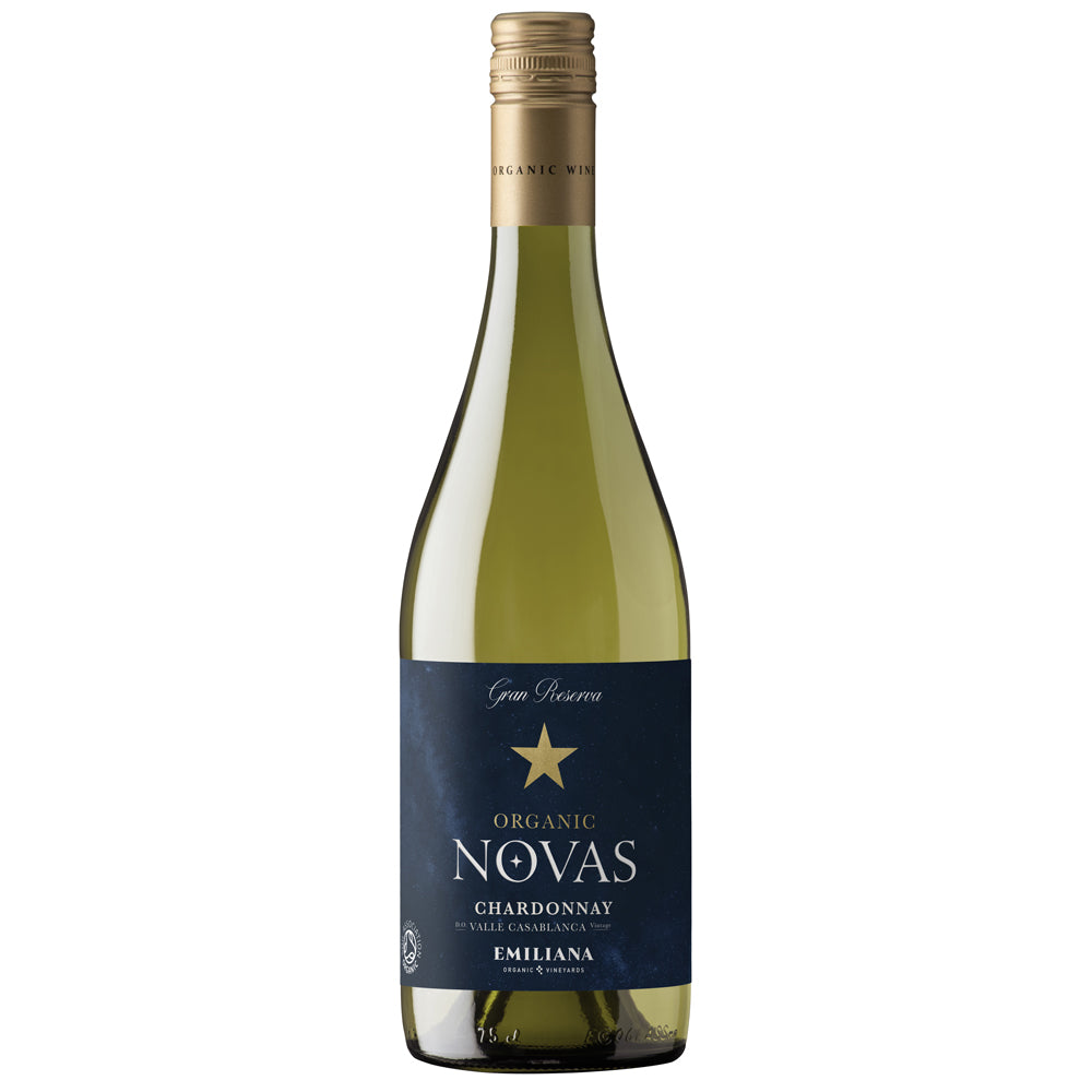 A bottle of Organic Novas Chardonnay Emiliana white wine, featuring a dark blue label with a gold star and a gold foil-wrapped neck, set against a plain white background.