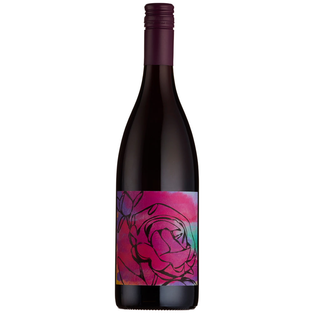 A dark glass wine bottle with a colorful floral label featuring a pink rose on a vibrant pink, purple, and blue watercolor background, topped with a dark purple capsule.