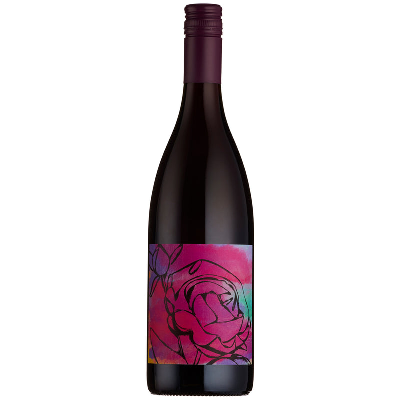 A dark glass wine bottle with a colorful floral label featuring a pink rose on a vibrant pink, purple, and blue watercolor background, topped with a dark purple capsule.