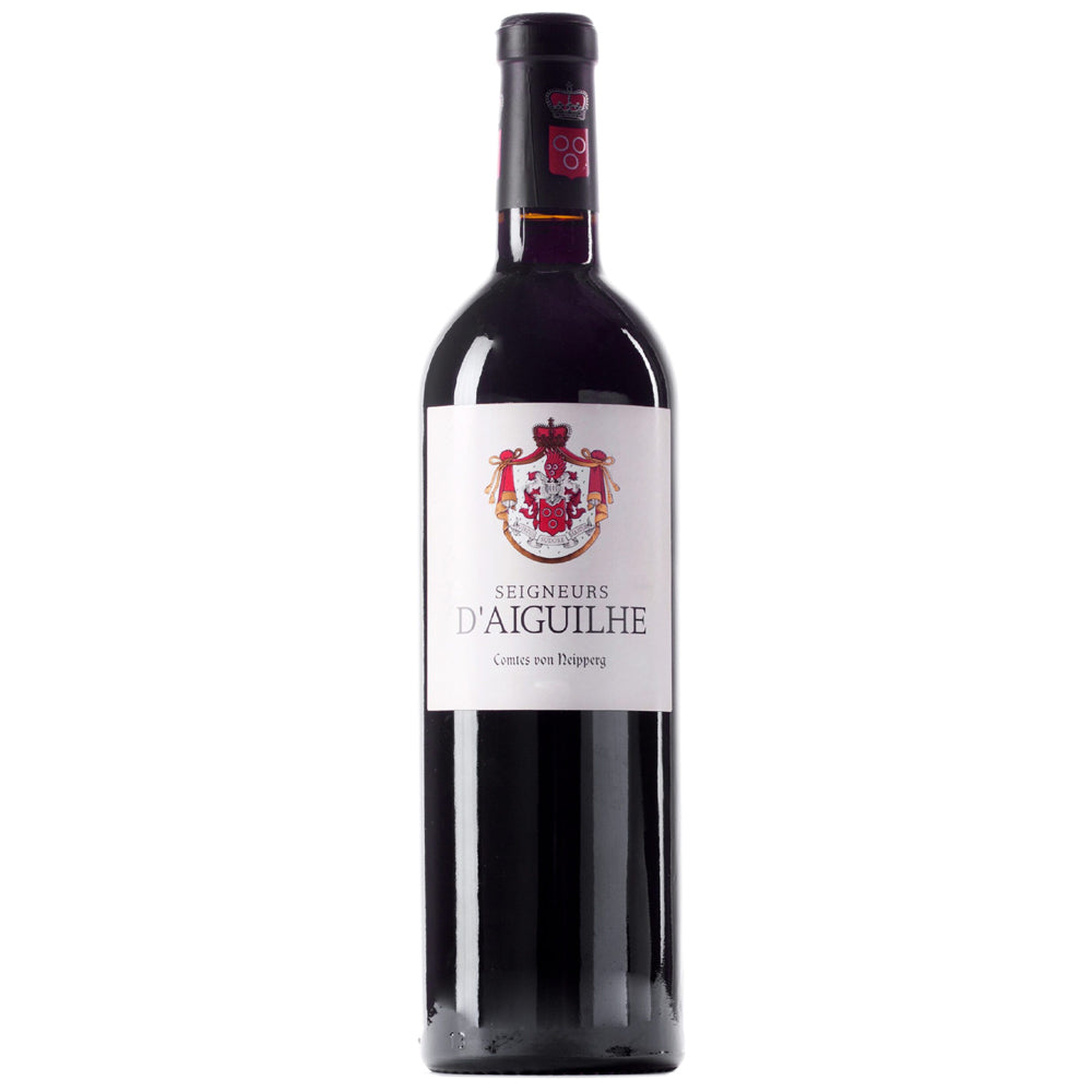 A bottle of Seigneurs d'Aiguilhe red wine with a white label and black foil capsule.