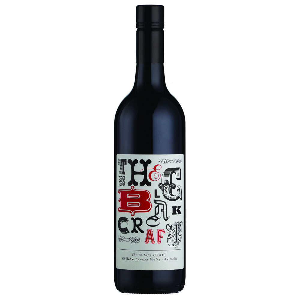 A bottle of The Black Craft Shiraz wine against a plain white background. The bottle is dark glass with a black cap and features a white label with stylized black and red lettering.