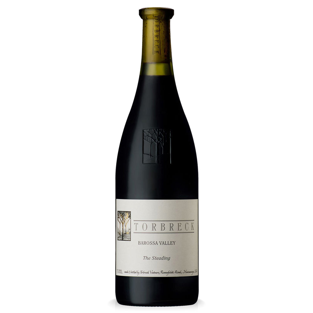 A bottle of Torbreck The Steading red wine, featuring a dark glass bottle with a cream-coloured label and a gold foil neck wrap, set against a plain white background.