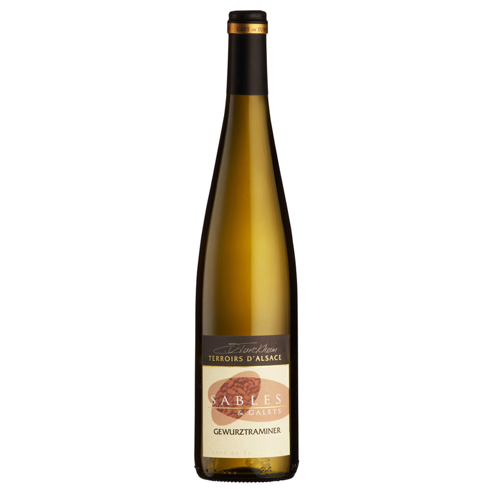 A bottle of Turckheim Sables et Galets Gewürztraminer wine with a dark green/brown glass body, a black and gold foil top, and a cream-colored label featuring a brown and gold design.