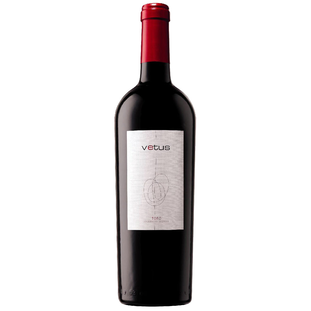 A bottle of Vetus red wine with a dark glass body, a red foil capsule at the neck, and a white label featuring the Vetus brand name and a minimalist circular graphic.